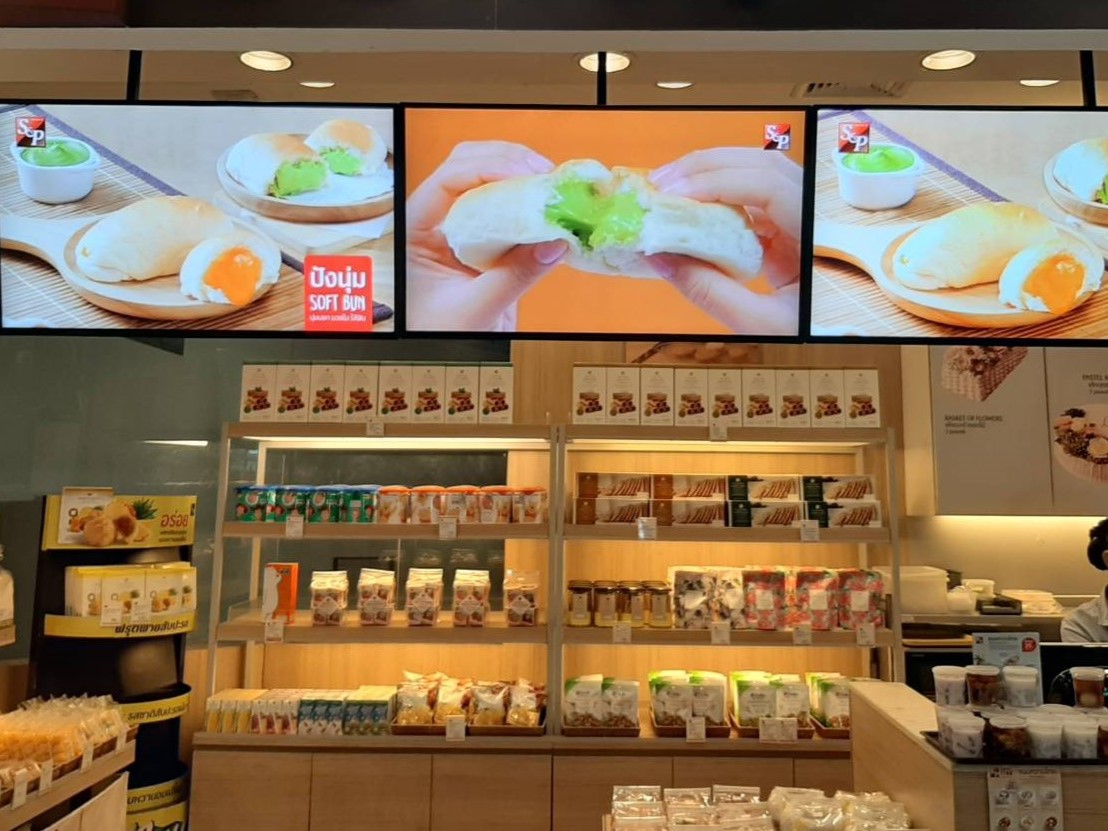Digital menu screens above a restaurant counter