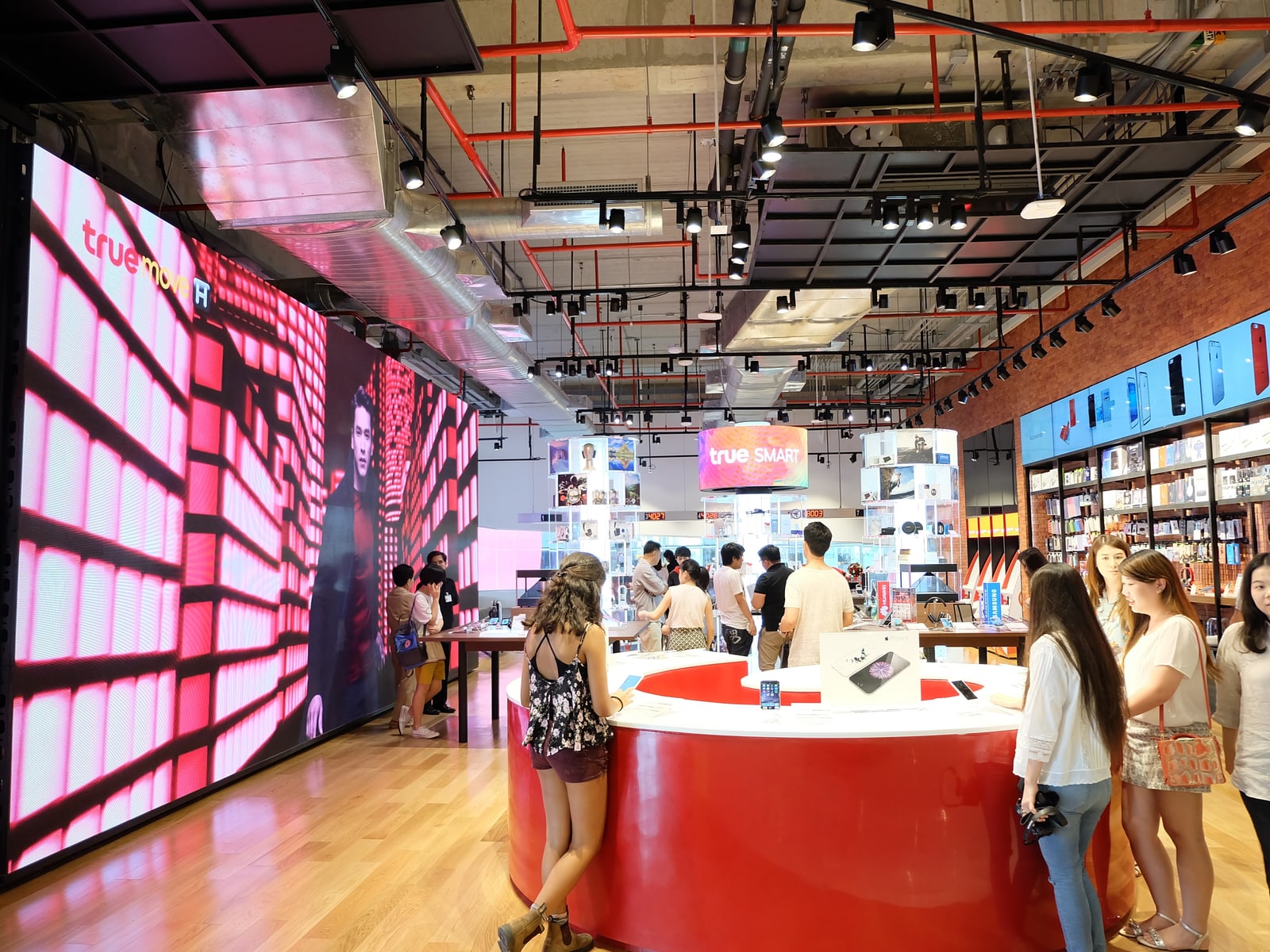 Large digital displays surrounding a True retail store interior